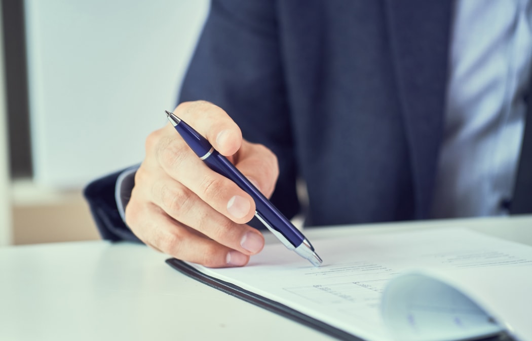 Businessman reading contract before making a deal.