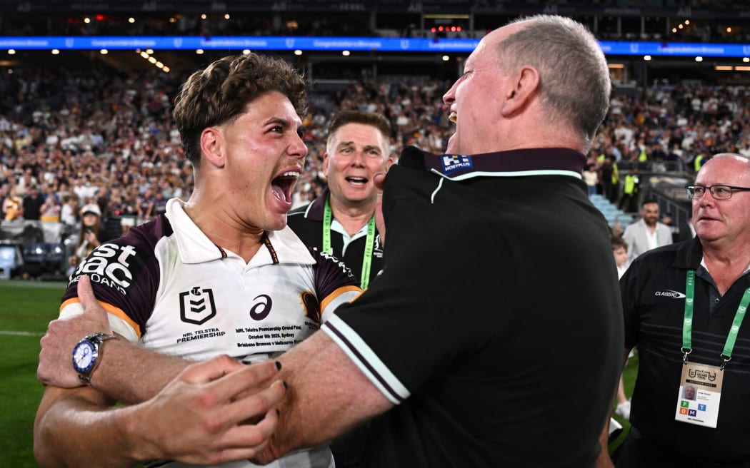 Reece Walsh (left) and Broncos head coach Michael Maguire celebrate after winning the NRL grand final against the Melbourne Storm at Accor Stadium in Sydney, October 5, 2025. (AAP Image/Dan Himbrechts/ Photosport)