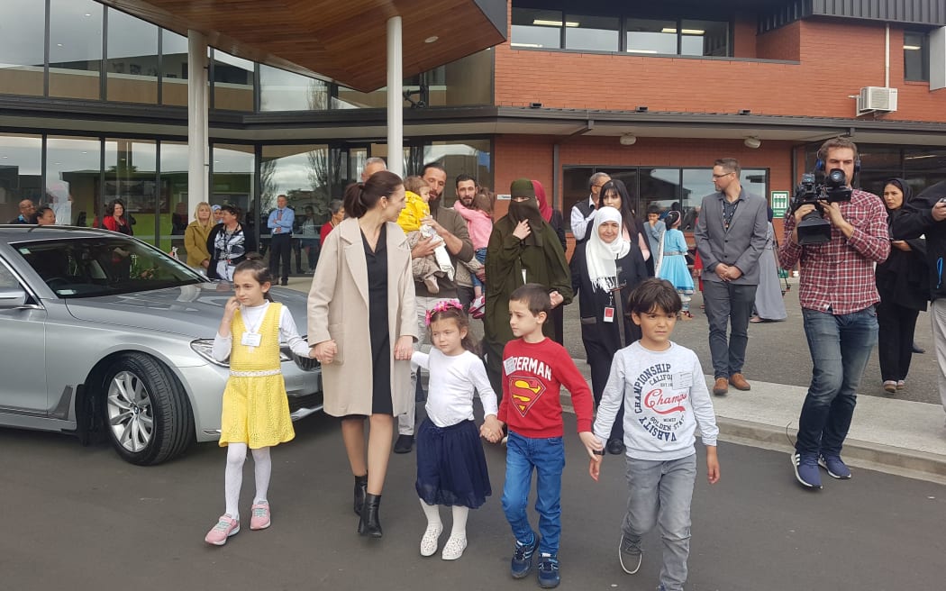 Prime Minister Jacinda Ardern with members of one of the families of the Christchurch attack victims, refugees who are being resettled in New Zealand.