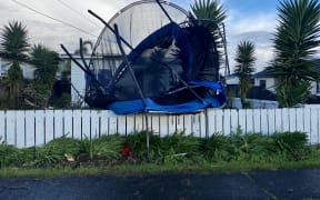 The tornado threw this trampoline on to a fence