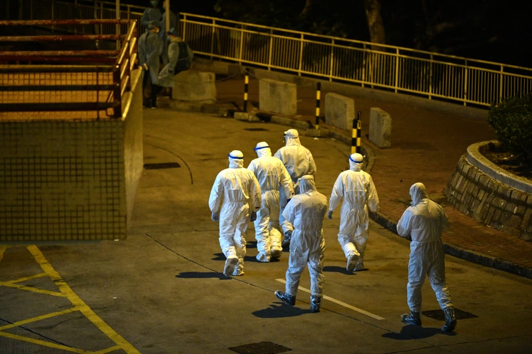 Medical personnel wearing protective suits in Hong Kong, early on February 11, 2020, after two people in the area were confirmed to have the coronavirus according to local newspaper reports.