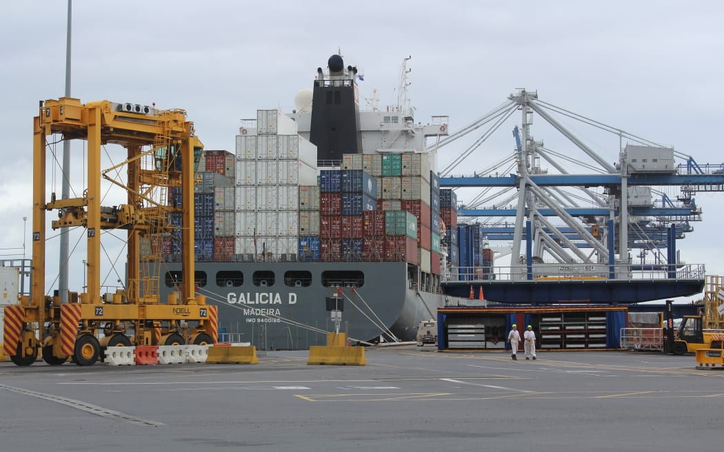 Cranes and container movers work to laod a ship at the Ports of Auckland