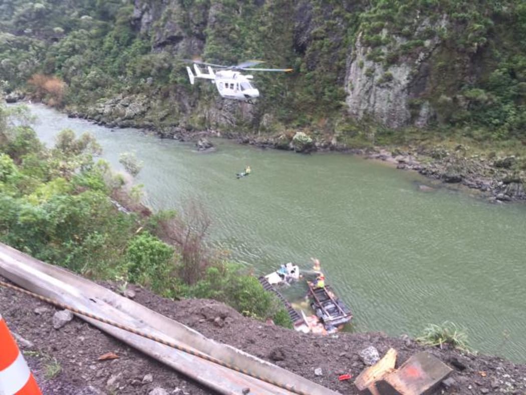 A paramedic being winched down from the helicopter to a crash site in the Manawatu Gorge on July 8, 2016.