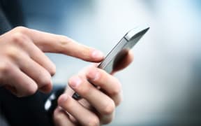 Close up of a man using mobile smart phone