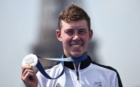 Silver medallist New Zealand's Hayden Wilde poses on the podium during the victory ceremony for the men's individual triathlon at the Paris 2024 Olympic Games in central Paris on July 31, 2024. (Photo by Anne-Christine POUJOULAT / AFP)