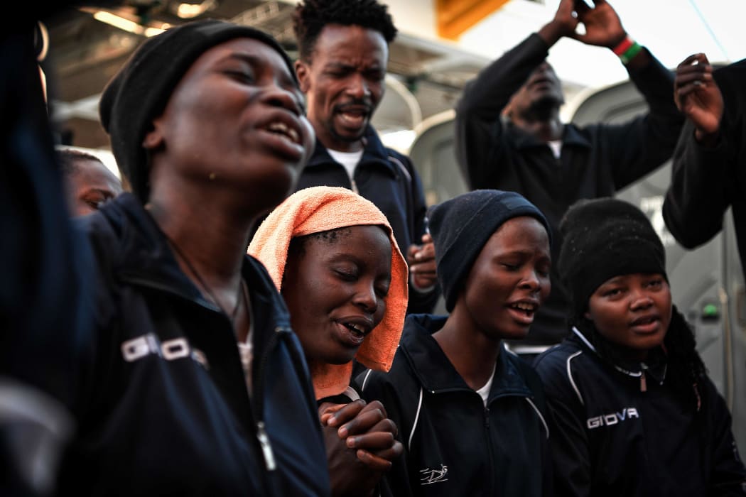 Christian migrants pray aboard the rescue ship MV Aquarius near the coast of Malta last year, heading to the Italian port of Messina.