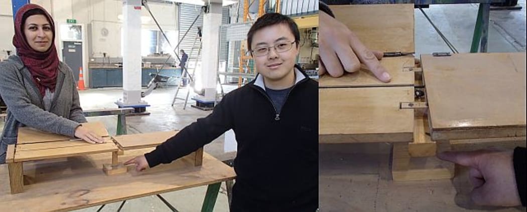 Zeinab Chegini (left) points to the elastic tendon running the length of the superstructure of a model low-damage bridge; in real life these post-tensioning tendons are made from steel cable. Royce Liu (right) is pointing out his area of interest, where the bridge pier sits on the