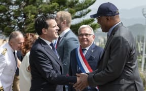 France's Minister of Overseas Manuel Valls (front L) greets the President of the Government of New Caledonia Alcide Ponga (R) as Senator Georges Naturel (C) looks on during his arrival for a military honours ceremony at the Croix de Lorraine in Noumea, France's Pacific territory of New Caledonia, on February 22, 2025. (Photo by Delphine MAYEUR / AFP)