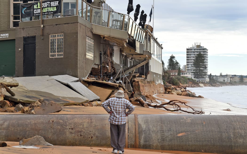 A man locals at the damage caused by a severe storm at Collaroy on Sydney's northern beaches.