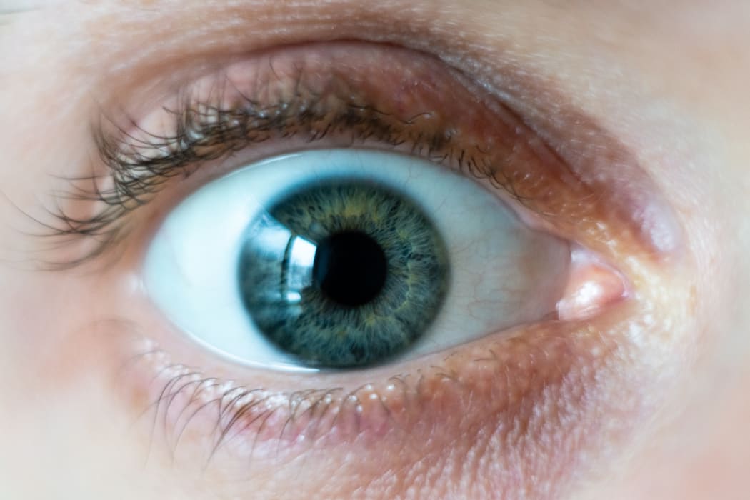 Close-up on male green wide open eye.