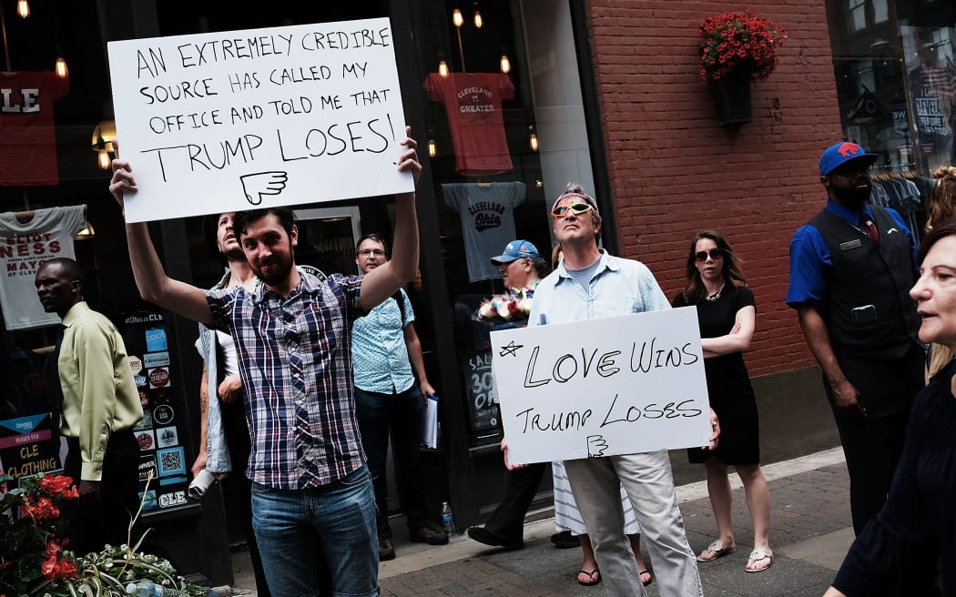 Protesters against Donald Trump's nomination hold signs outside the Republican convention.