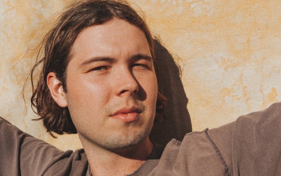 Musician Will Gillivray, aka Goodwill, standing in the sunshine