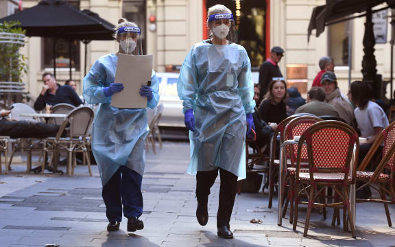 Health department officials arrive to inspect a restaurant and bar in Melbourne on May 12, 2021.