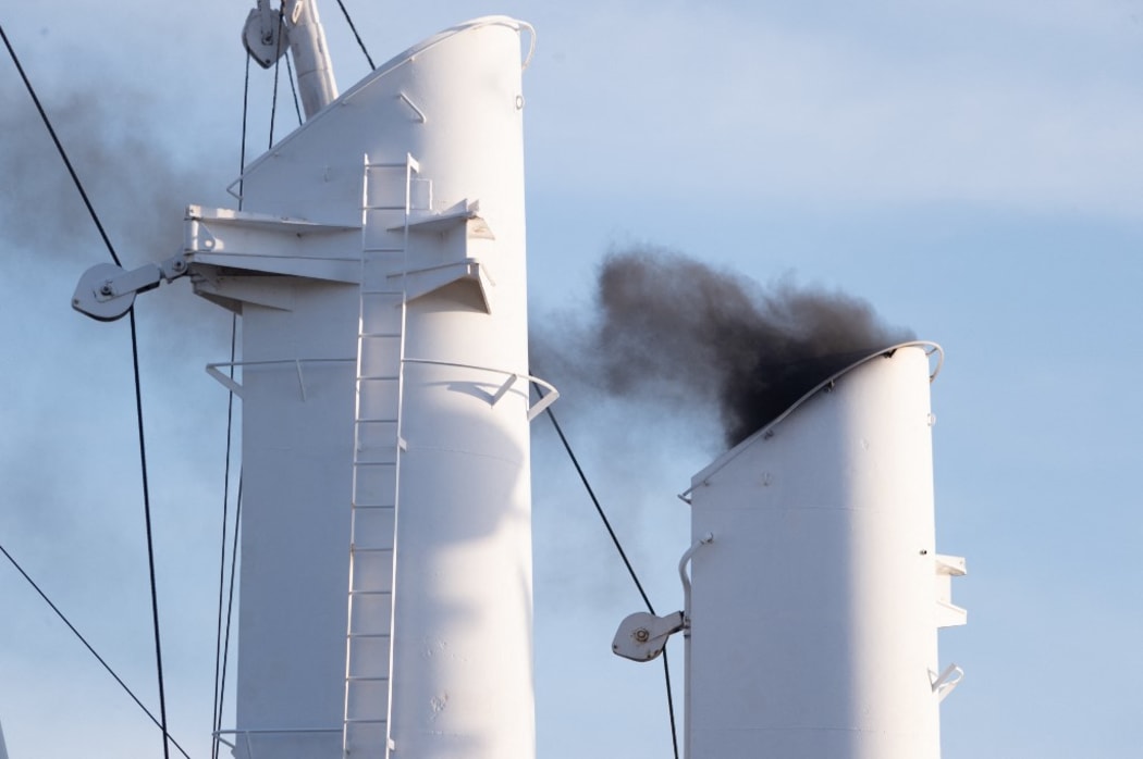 14 September 2019, Hamburg: The heavily smoking chimney of a ship at the Hamburg Cruise Days. In the course of the evening a parade with cruise ships and fireworks was held.