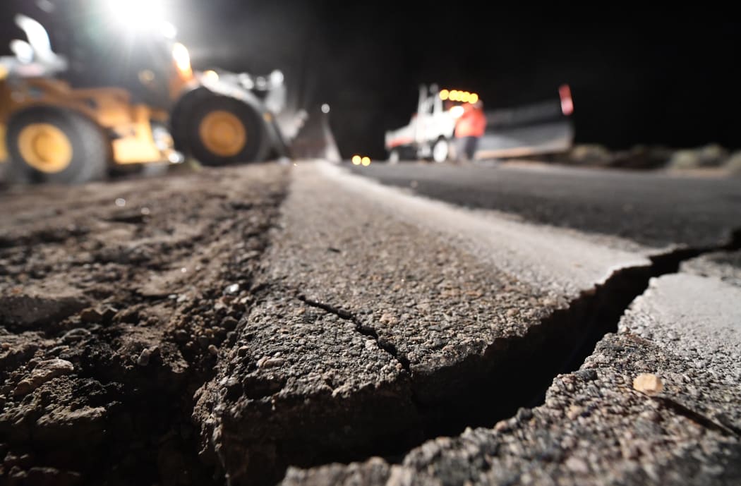 Highway workers repair a hole that opened in the road as a result of the July 5, 2019 earthquake, in Ridgecrest, California, about 150 miles (241km) north of Los Angeles,