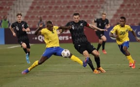 Solomon Islands defender Leon Kofana and New Zealand striker Chris Wood battle for possession.