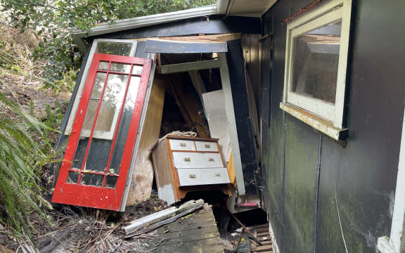 The bach was knocked off its foundations by a wall of mud and debris.