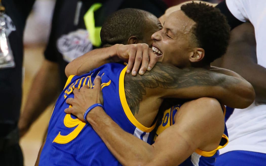 Stephen Curry celebrates with teammate Andre Iguodala.