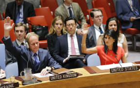 US Ambassador to the United Nations Nikki Haley (R) and Britain's Ambassador Matthew Rycroft vote on a US-drafted resolution toughening sanctions on North Korea, at the United Nations Headquarters in New York, on August 5, 2017.