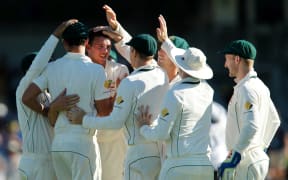 The Australian cricketers celebrate a Josh Hazlewood wicket during their Test series against South Africa