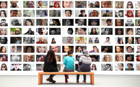 How do we re-shape our thinking around diversity. People watching many images of faces.