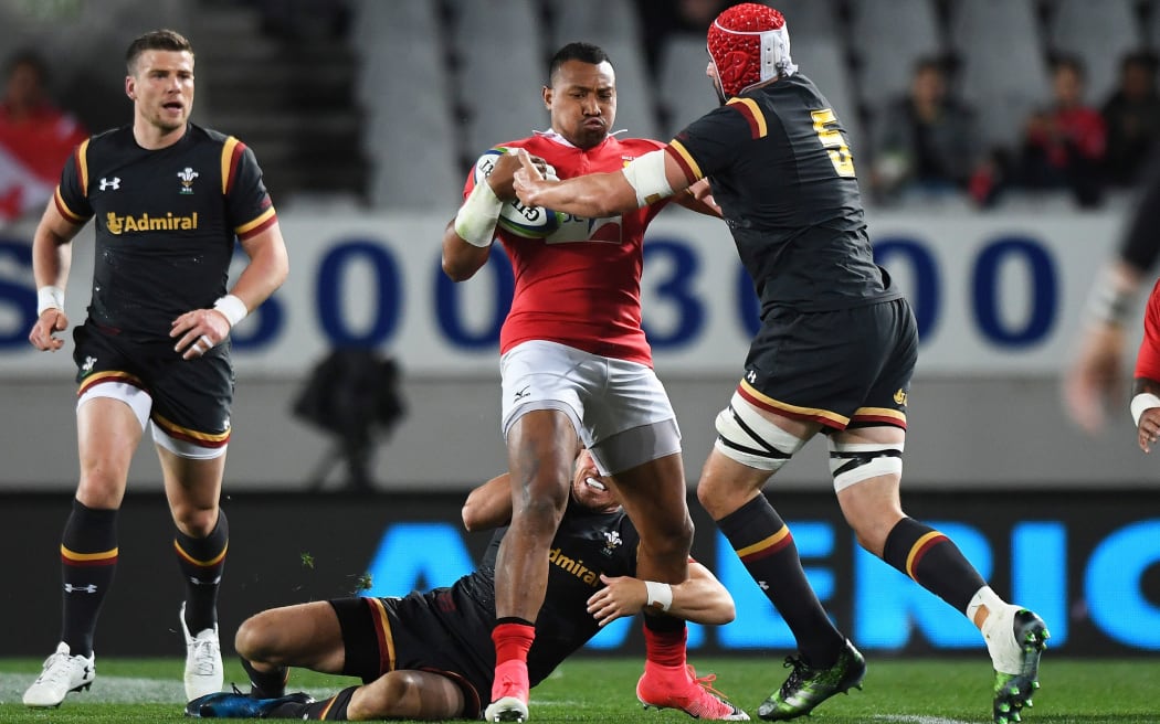 Tonga fullback David Halaifonua holds off the Welsh defence.
