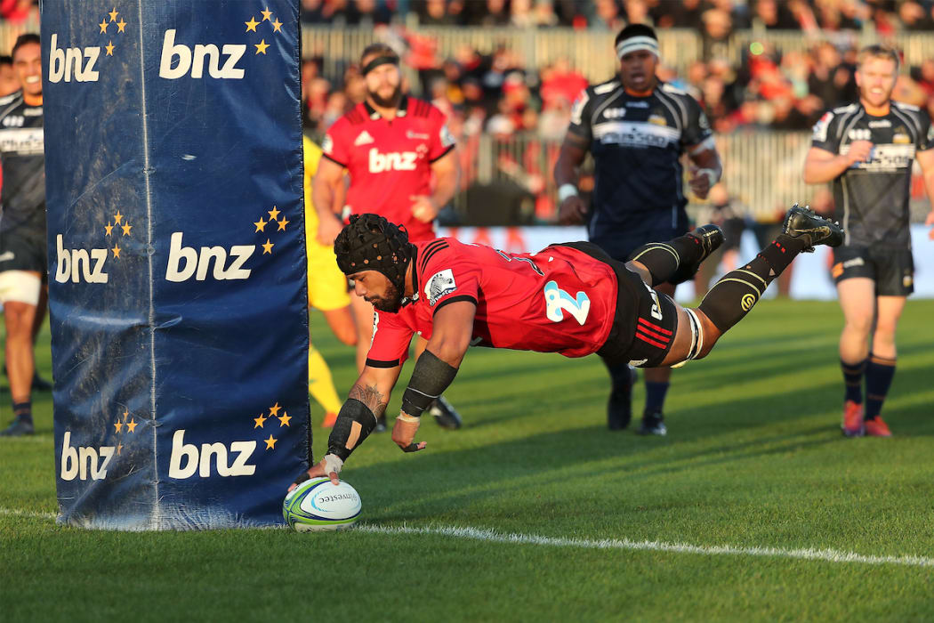 Jordan Taufua of the Crusaders dives over to score a try. against the ACT Brumbies.