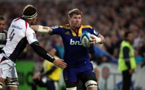 Adam Thomson on fends off Luke Jones.
Investec Super Rugby - Highlanders v Rebels, 30 March 2012,