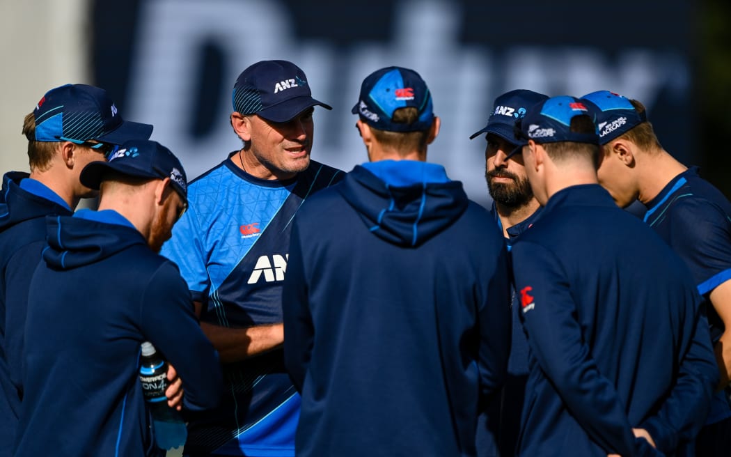 Bowling coach Kyle Mills talks with the bowlers