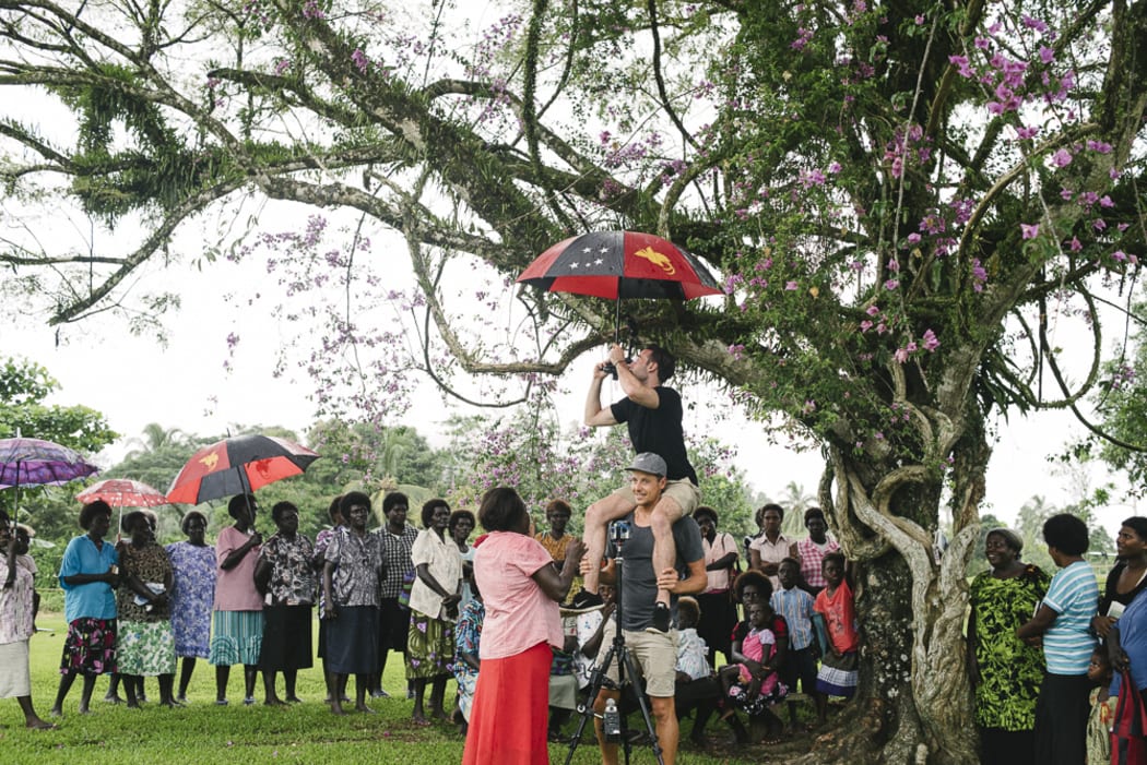 The World Bank’s VR film crew setting up a shot underneath the largest Bougainvillea tree in Konnou.