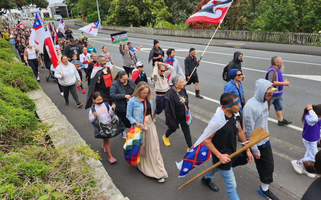 Protesters walk along Bank St, Whangarei.