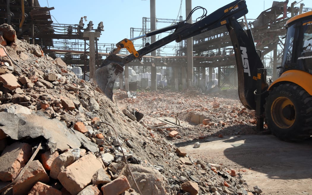 An excavator is removing the rubble at an energy facility that was damaged by Russian shelling and is being repaired in Kharkiv, northeastern Ukraine, on April 10, 2024. (Photo by Ukrinform/NurPhoto) (Photo by Vyacheslav Madiyevskyy / NurPhoto / NurPhoto via AFP)