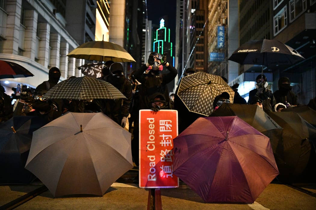 Protesters form a front line against police following a pro-democracy rally in Hong Kong on December 8, 2019.