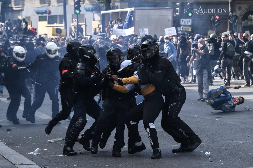 French riot police forces detain a protester during a rally as part of the 'Black Lives Matter' worldwide protests against racism and police brutality.