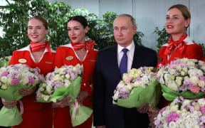 Russian President Vladimir Putin is photographed with representatives of the flight crew of Russian airlines during his visit to the Aeroflot aviation training complex, in Moscow region, Russia.