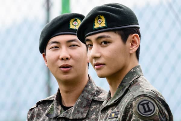 K-pop boy band BTS member V (R) looks on as RM reacts, after their release from 18 months of South Korean military service.