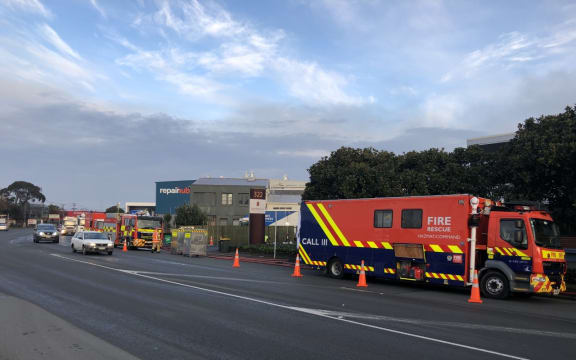 Fire trucks near the site of a fire at an industrial building in Penrose.