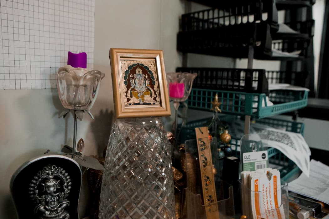 Pictures and a statue of Ganesh in Halima's office
