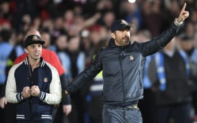 US actors and Wrexham owners Rob McElhenney, left, and Ryan Reynolds celebrate after their team won through to the English Football League after beating Boreham Wood, on 22 April, 2023.