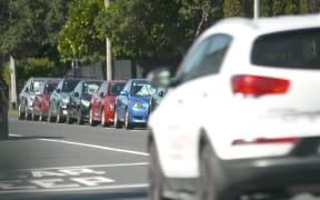 Cars parked on an Auckland road.