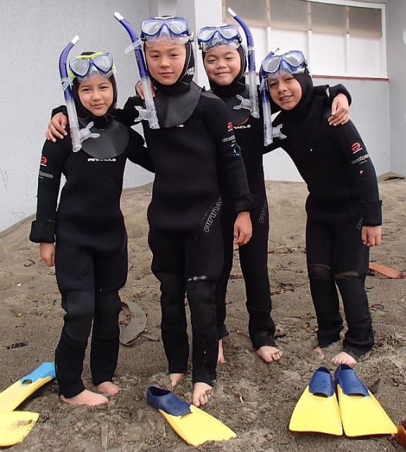 These four students from a year 5 and 6 class have already had an introductory snorkel session in a swimming pool and a snorkel in an unprotected bay, so they were quick to get ready with their wetsuits and snorkelling gear