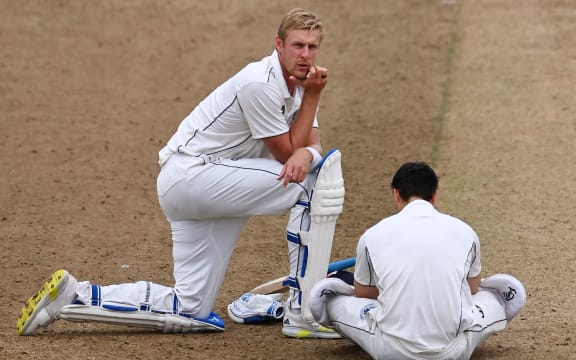 Kyle Jamieson and Mark Chapman wait for the umpires to start play after a delay for bad light.