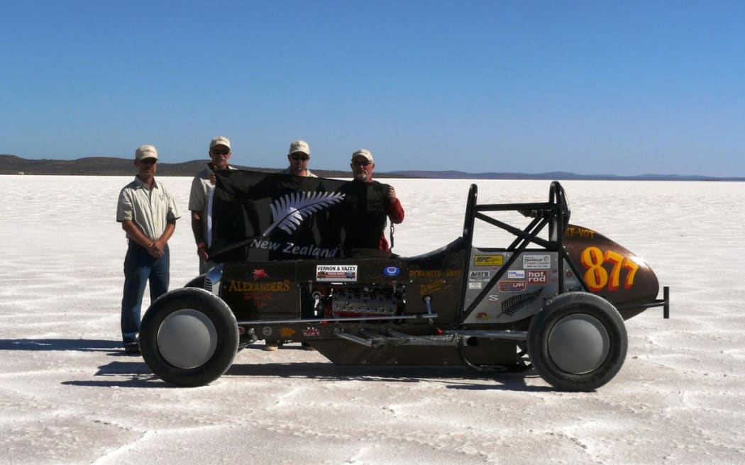 Description of Dave Alexander and team in front of vehicle