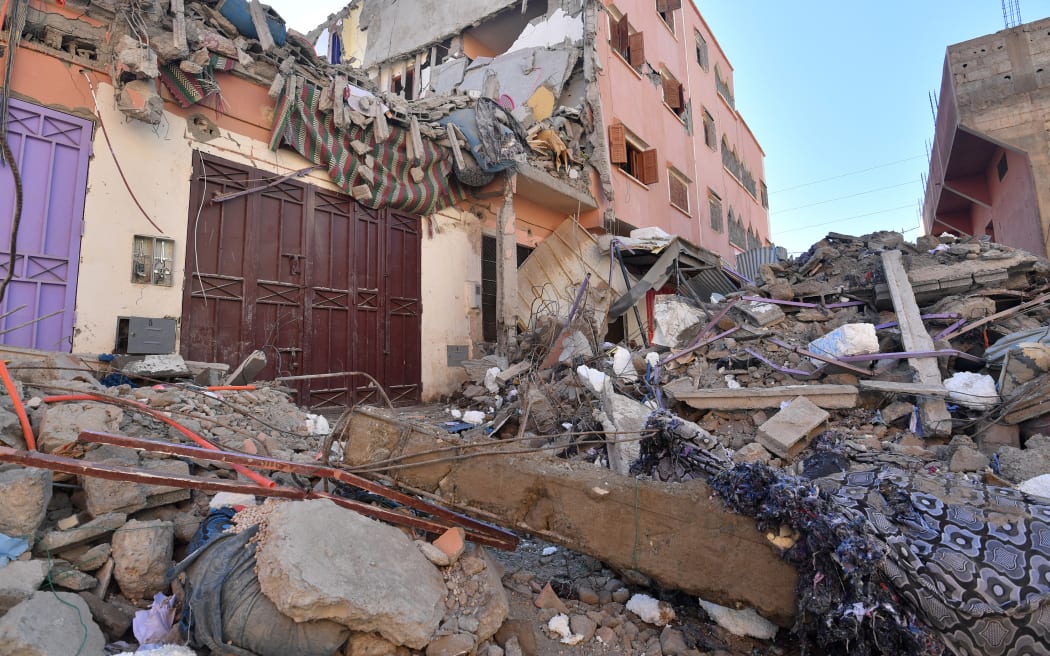 Building rubble blocks a street in Mzouda village in Morocco's Chichaoua province following a devastating earthquake, on 8 September, 2023 - the strongest-ever to hit the country - that killed more than 2,000 people, as rescue teams raced to find survivors trapped in the rubble of flattened villages.