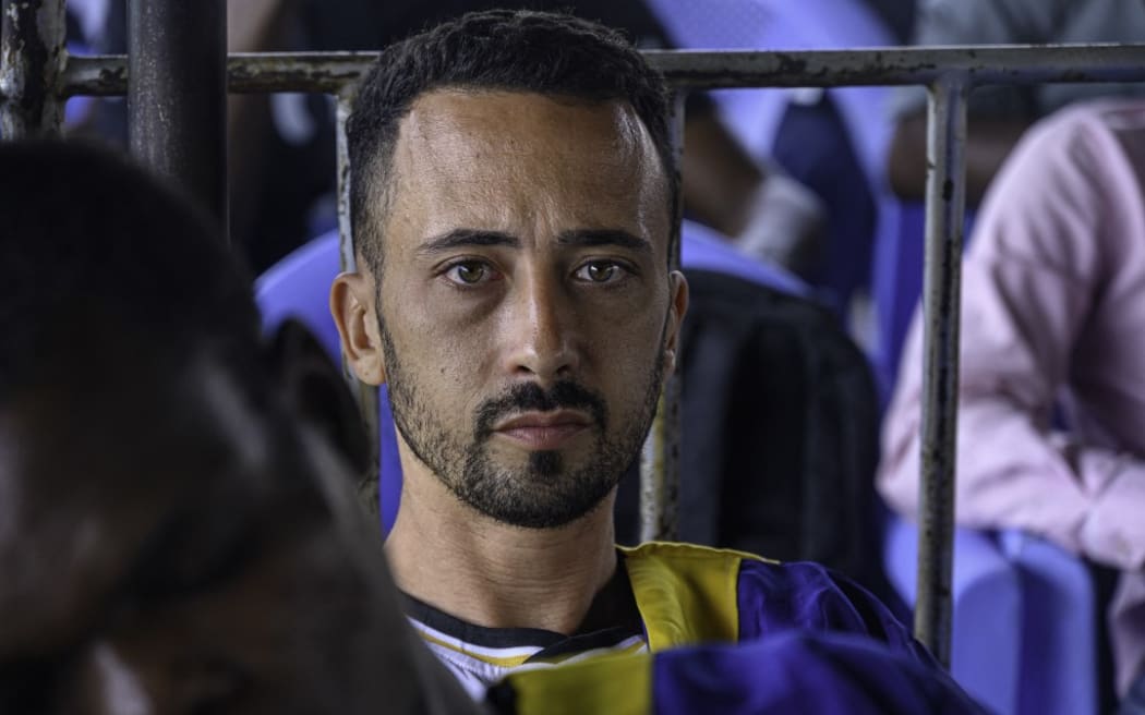 US national Benjamin Reuben Zalman-Polun (C), accused of a failed coup attempt, attends a trial hearing at Ndolo prison in Kinshasa on September 13, 2024. Three Americans were among 37 people sentenced to death on September 13, 2024 in the Democratic Republic of Congo over what the army says was a coup attempt.
Death sentences were also handed down to a Belgian, Briton and Canadian, all naturalised Congolese. (Photo by Hardy BOPE / AFP)