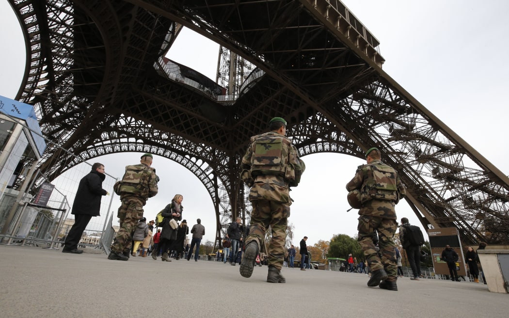 French soldiers patrol the area at the foot of the Eiffel Tower in Paris on November 14