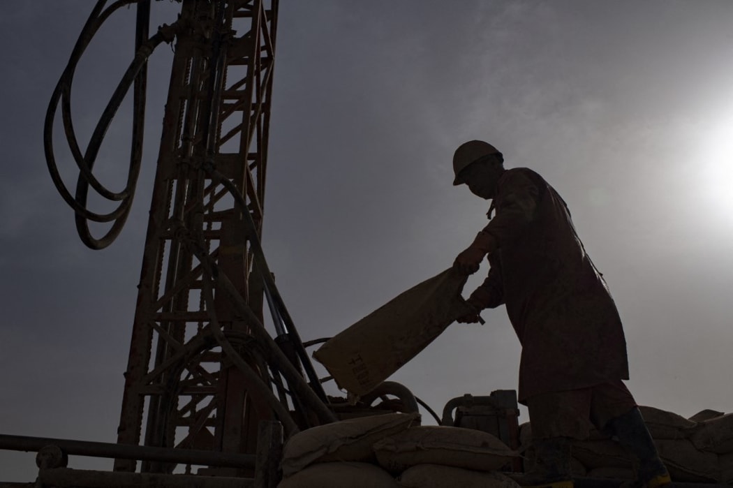 A worker of the geophysical survey team works in the Taklimakan Desert, northwest China's Xinjiang Uygur Autonomous Region