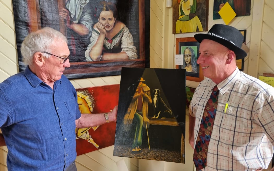 Graham Christensen, left, and Richard Aslett look over one of Graham's two entries.