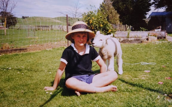 Busby as a lamb with four-year-old Olivia.