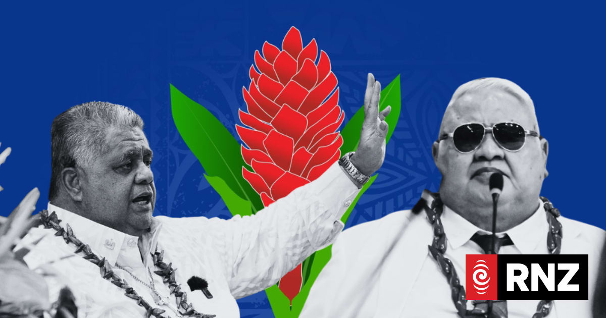 Two men in garlands seated on either side of a large red and green flower graphic.